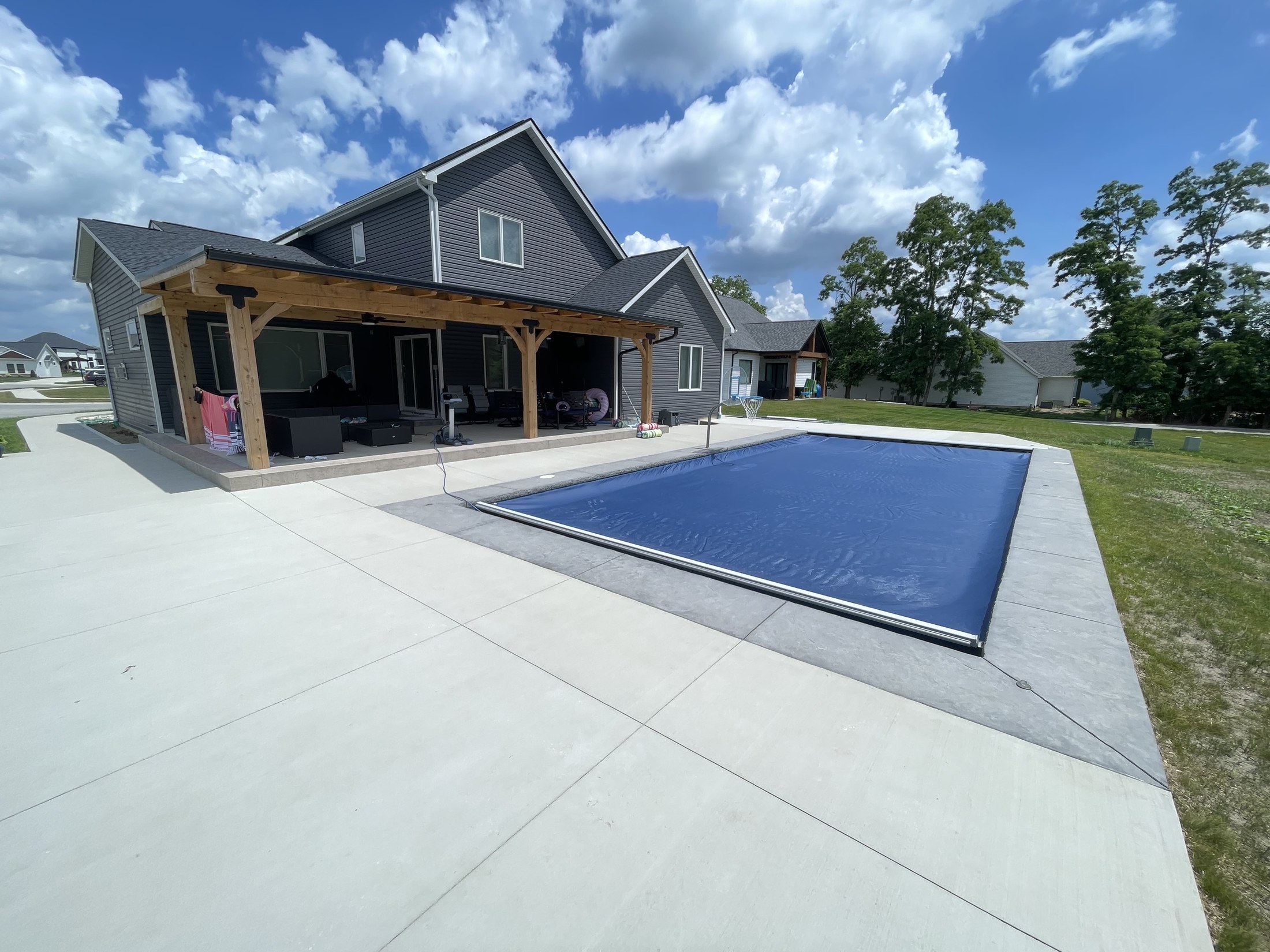 Open concrete pool and outdoor living space in Huntertown