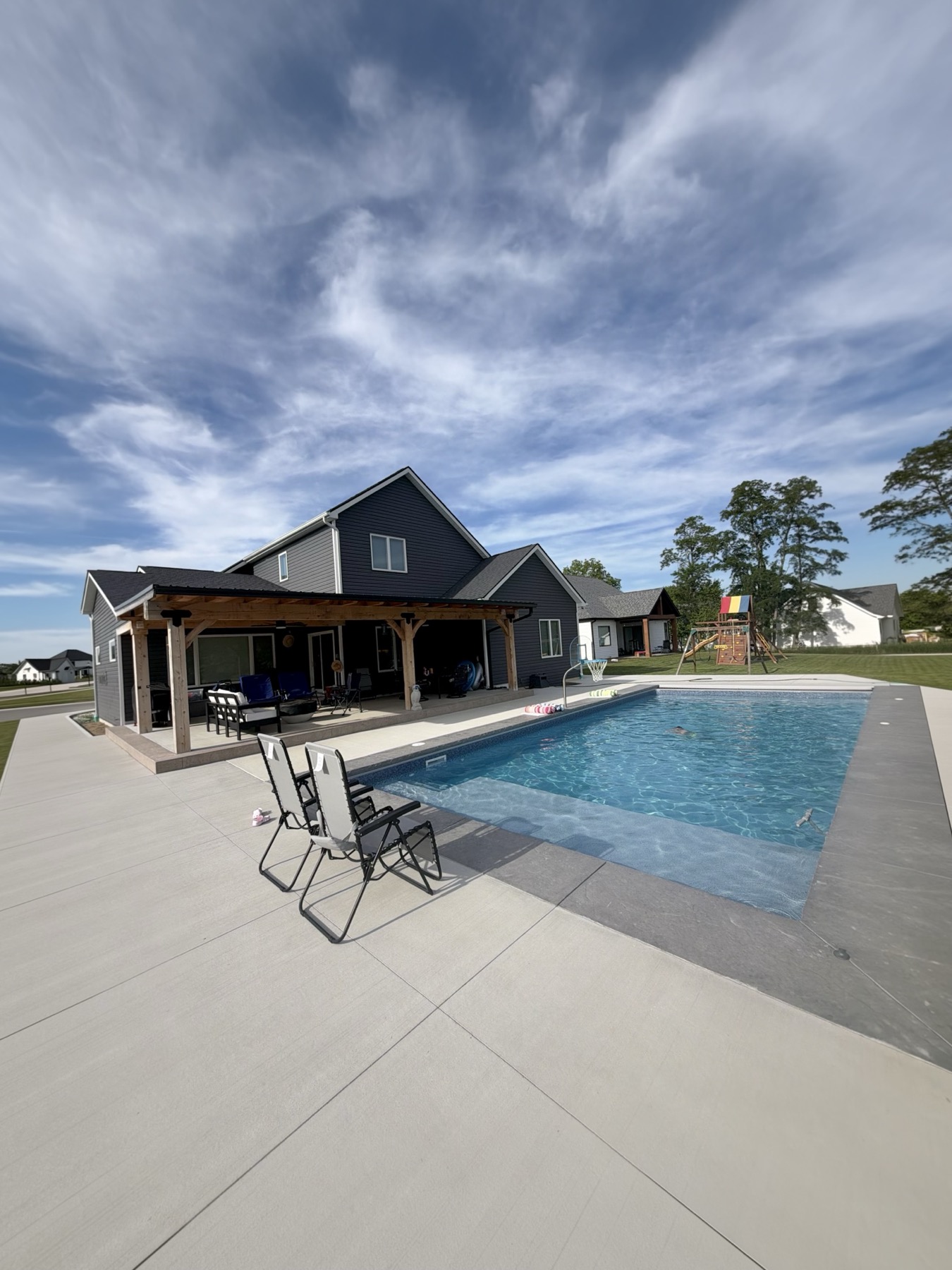 Huntertown pool with sun shelf and covered patio